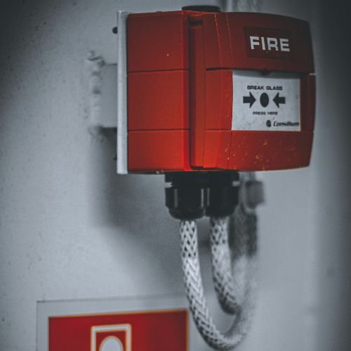 Technician inspecting a fire alarm system for DCD approval in Dubai