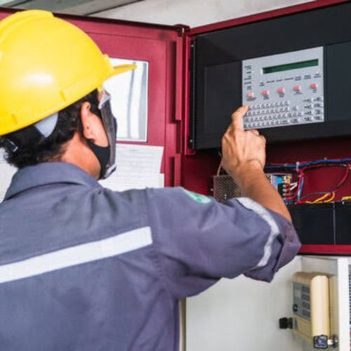 Fire system maintenance technician testing fire alarm panel