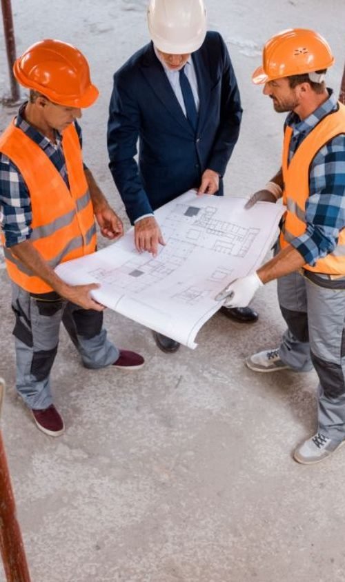 Commercial interior fit out contractor reviewing project drawings on site